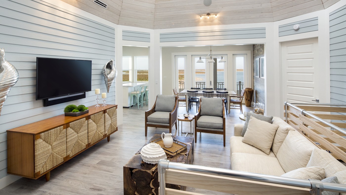 Coastal living room with shiplap walls and water views